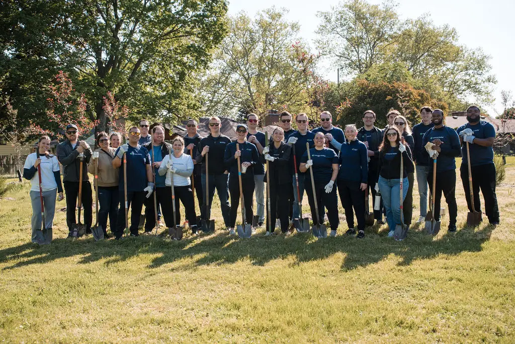 group of people holding shovels