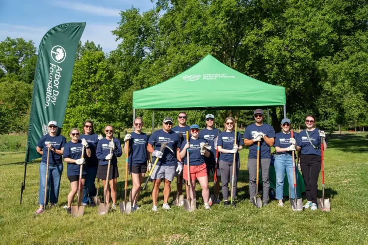 group of tree planting volunteers in blue shirts