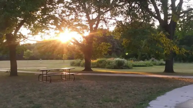 picnic table on a hill at sunset